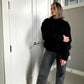 woman wearing a black crew neck sweatshirt